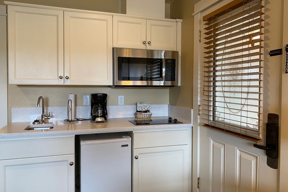 suite, 1 queen bed with sofa bed, kitchenette (1st floor, not pet friendly) | private kitchenette | fridge, microwave, coffee/tea maker, cookware/dishes/utensils