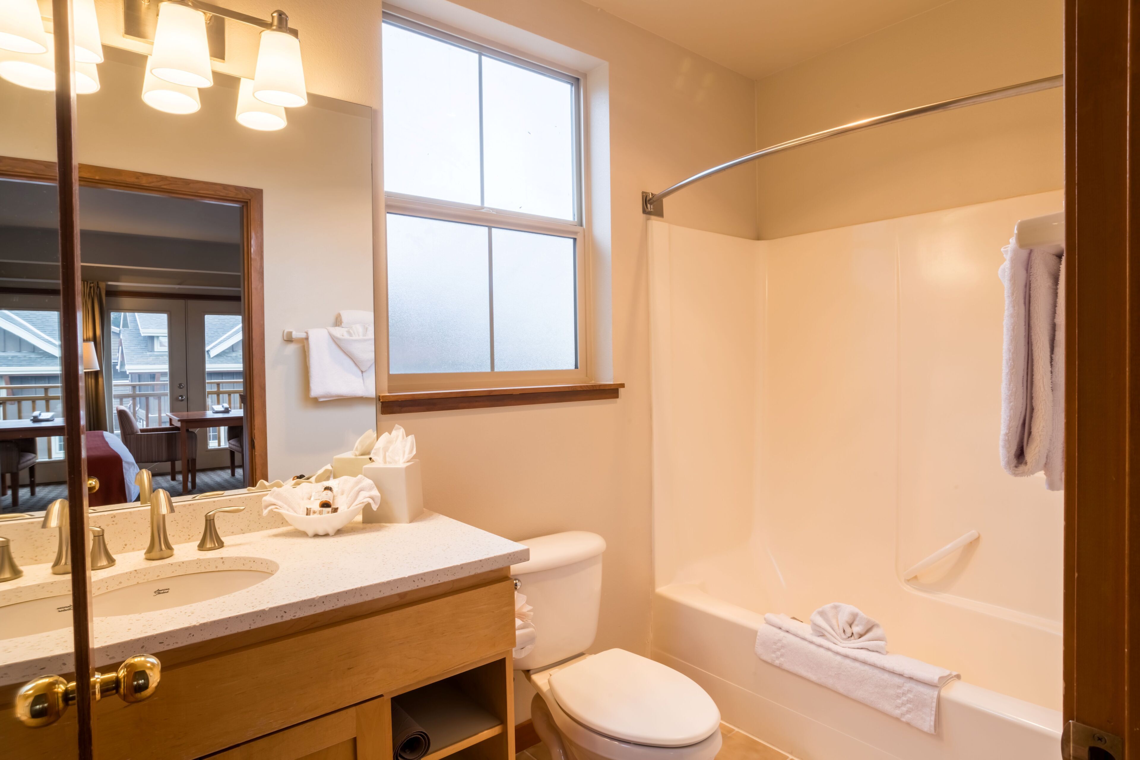 A bathroom with a sink, toilet, and bathtub.