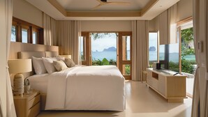 A modern bedroom with a large bed, a TV, and a view of the sea. - Villa Macaque and Villa Languor (Krabi)