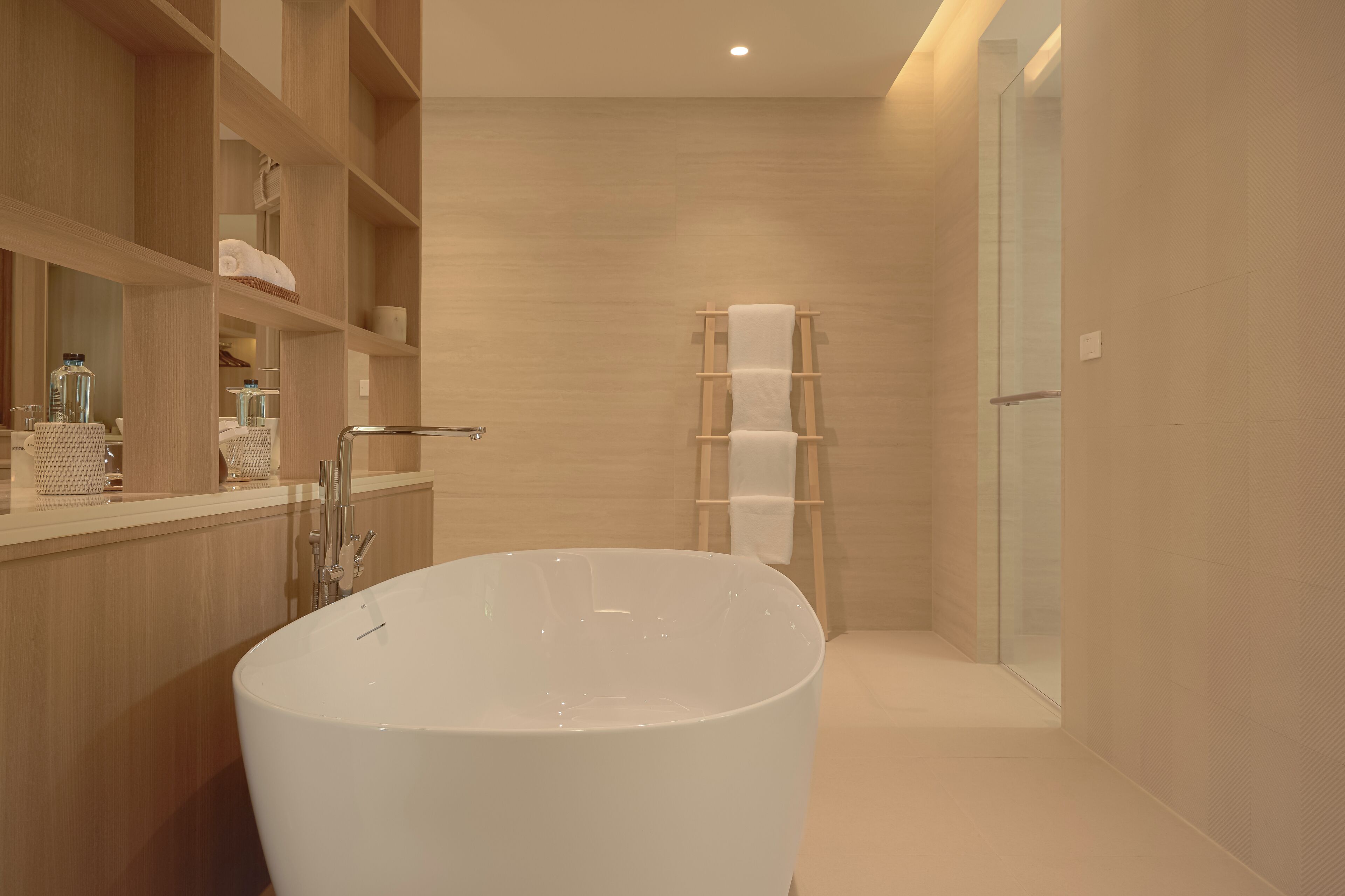 A modern bathroom with a freestanding bathtub, wooden shelving, and a glass shower enclosure.