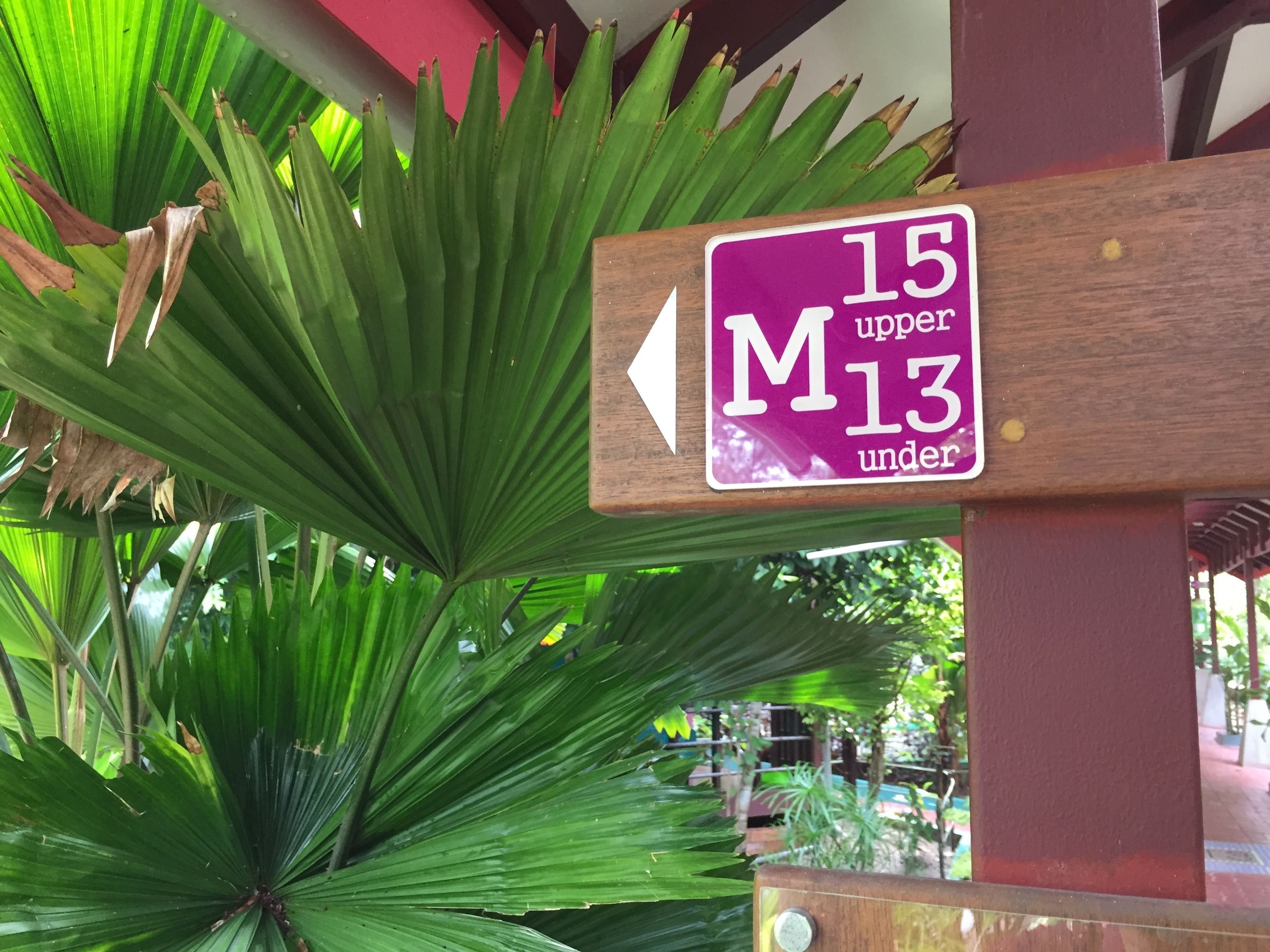 A directional sign with '15 upper' and '13 under' indicating room numbers.