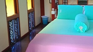 A room with a bed, wooden paneling, a wall-mounted air conditioner, and a window with a view. - T Star Cottage (Langkawi)