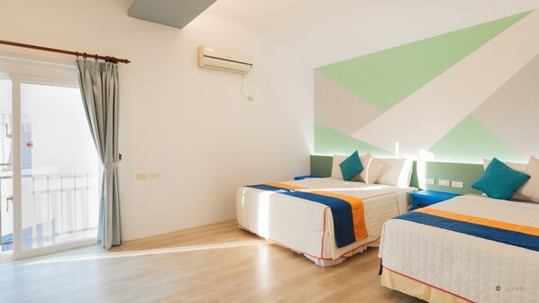 A hotel room with two beds, a large window with curtains, an air conditioning unit, and a geometric wall design. - Ocean Star B&B (Hengchun)
