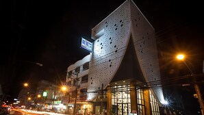 A modern building with a unique perforated facade and large windows. - The Bed Hatyai (Hat Yai)