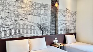 A hotel room with two beds, a brick accent wall, and a cityscape mural. - Martin Wales Hotel Kenting (Hengchun)