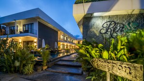 A modern hotel with a reception area, a pool, and a well-maintained garden. - Ren Resort (Sihanoukville)
