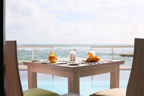A dining table set for two with a view of the ocean. - Coral Rock by Bansei (Hikkaduwa)