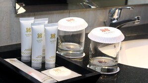Toiletries on a hotel counter, including shampoo, conditioner, and shower gel. - Sotis Hotel Falatehan Jakarta (Jakarta)