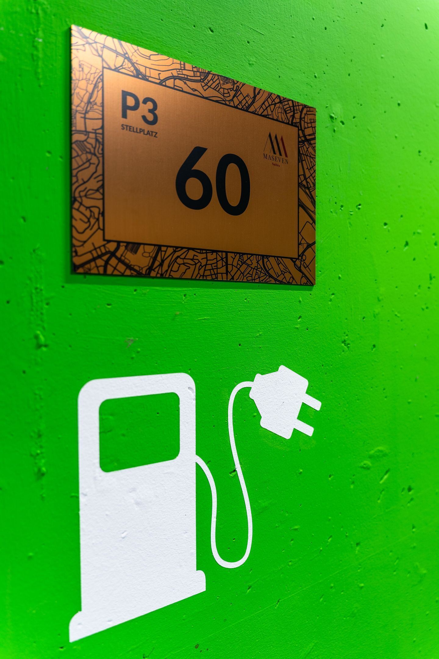 A sign with 'P3' and '60' on a green wall, and a white plug icon.