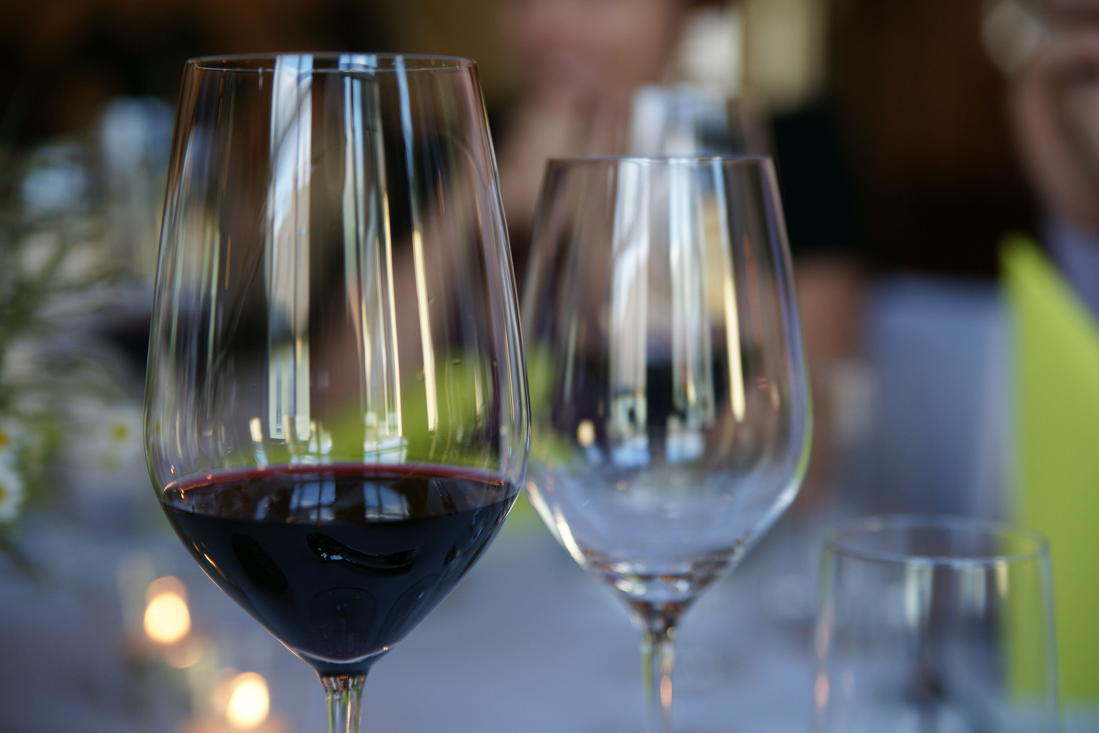 A close-up of wine glasses on a table with a blurred background.