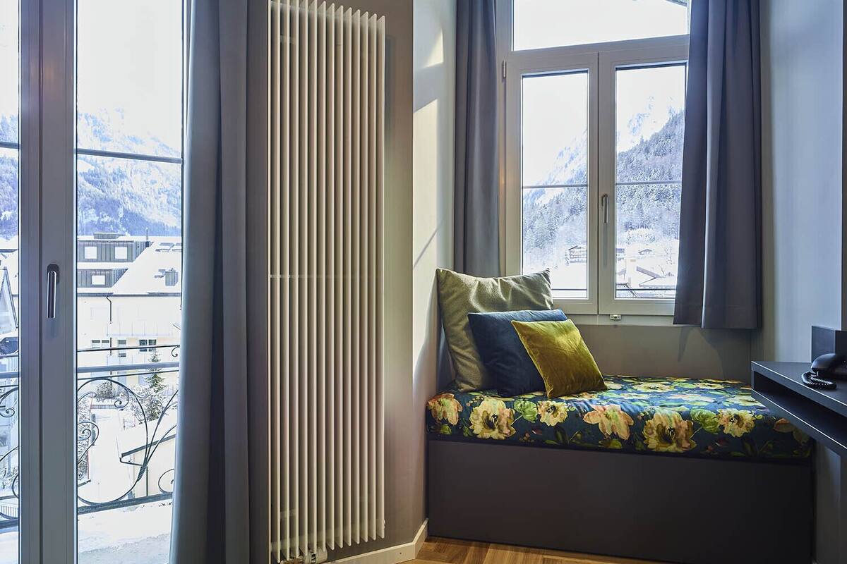 deluxe double room, mountain view (large) | living area | 60-inch flat-screen tv with cable channels, tv, dvd player