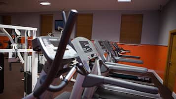 A gym with multiple treadmills and exercise equipment.