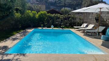 Seasonal outdoor pool, open 9:00 AM to 6:00 PM, pool umbrellas