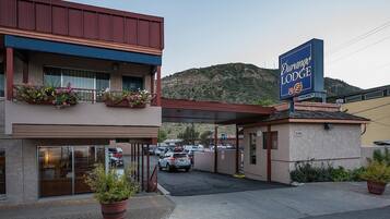 A Durango Lodge with a parking lot, a covered entrance, and a mountainous backdrop.