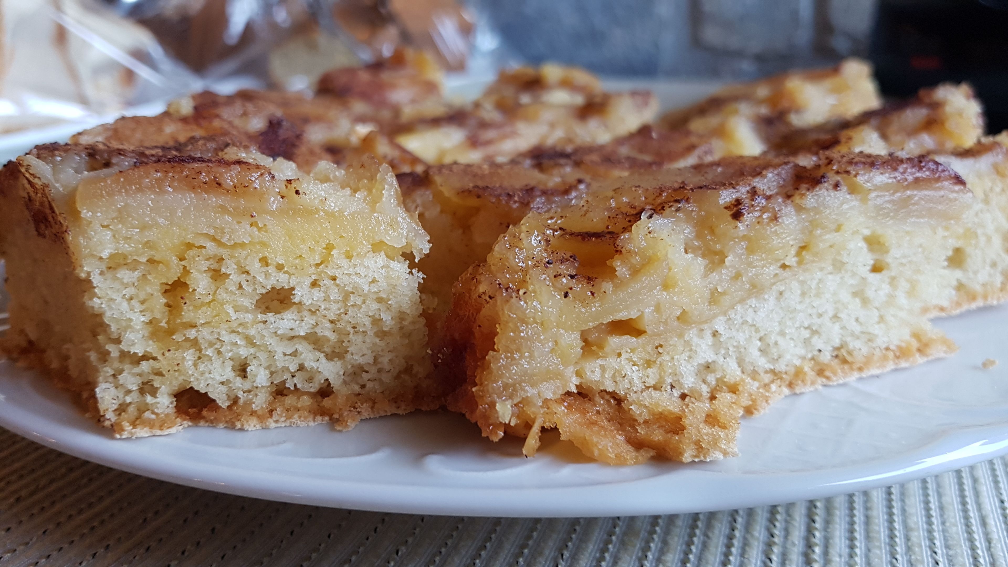 A plate of pineapple upside-down cake slices on a white plate.
