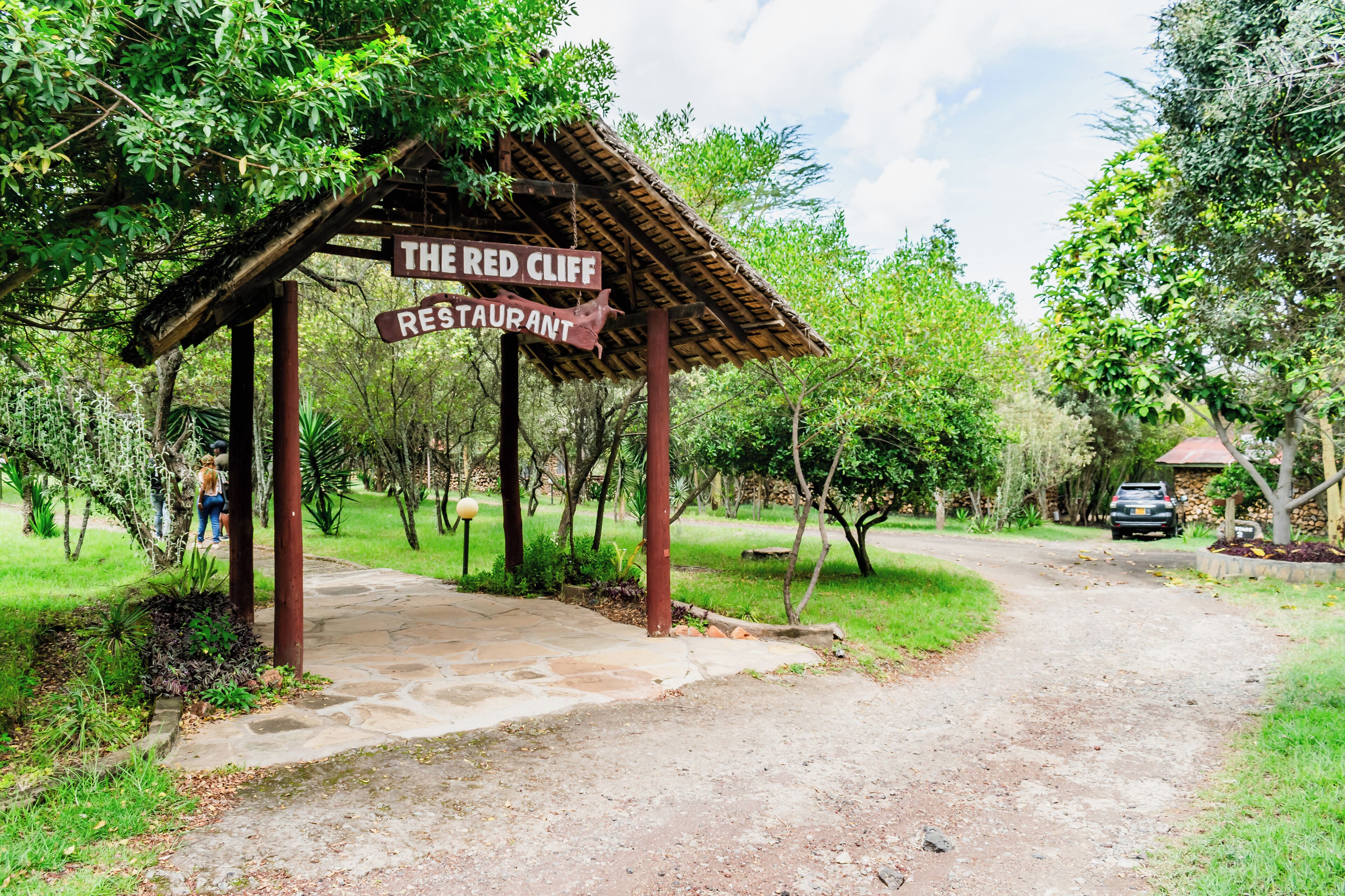 A rustic wooden structure labeled "The Red Cliff Restaurant" with a dirt path leading to it.