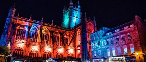 A historic building with Gothic architecture, including pointed arches and a clock tower.