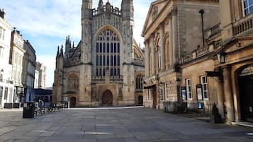 A historic building with a large arched entrance and Gothic architectural details.
