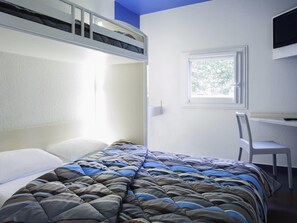 A bunk bed with a striped comforter, a desk with a chair, and a window with a view of trees. - hotelF1 Saint Etienne La Grand Croix (La Grand-Croix)