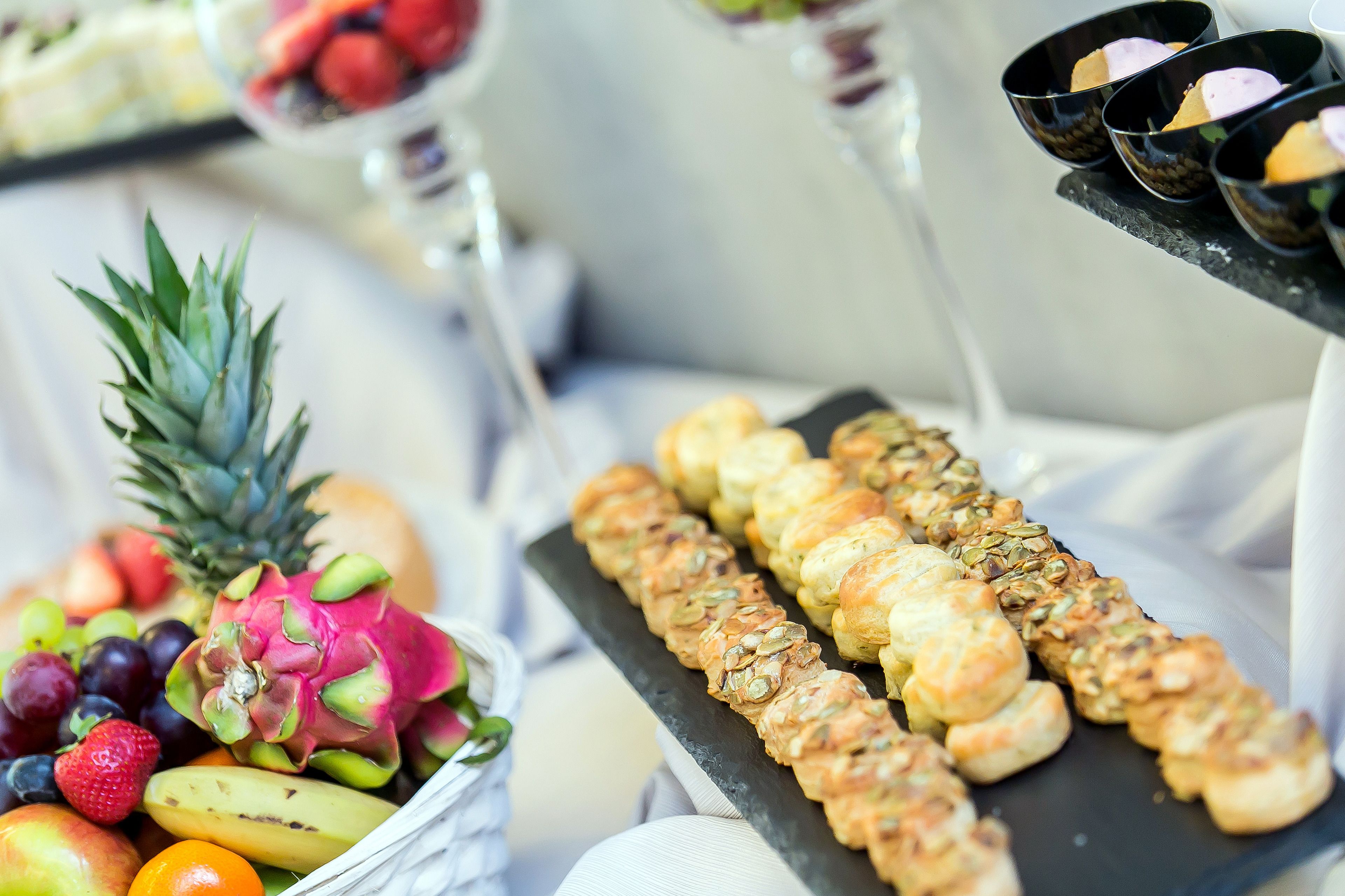 A fruit platter with a dragon fruit, pineapple, and assorted berries.