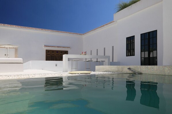 A modern pool area with a clear pool, white walls, and a minimalist design. - Dar Sabri (Nabeul)