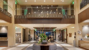 A spacious lobby with a central seating area, a reception desk, and a staircase leading to an upper level. - Best Western Premier Boulder Falls Inn (Lebanon)
