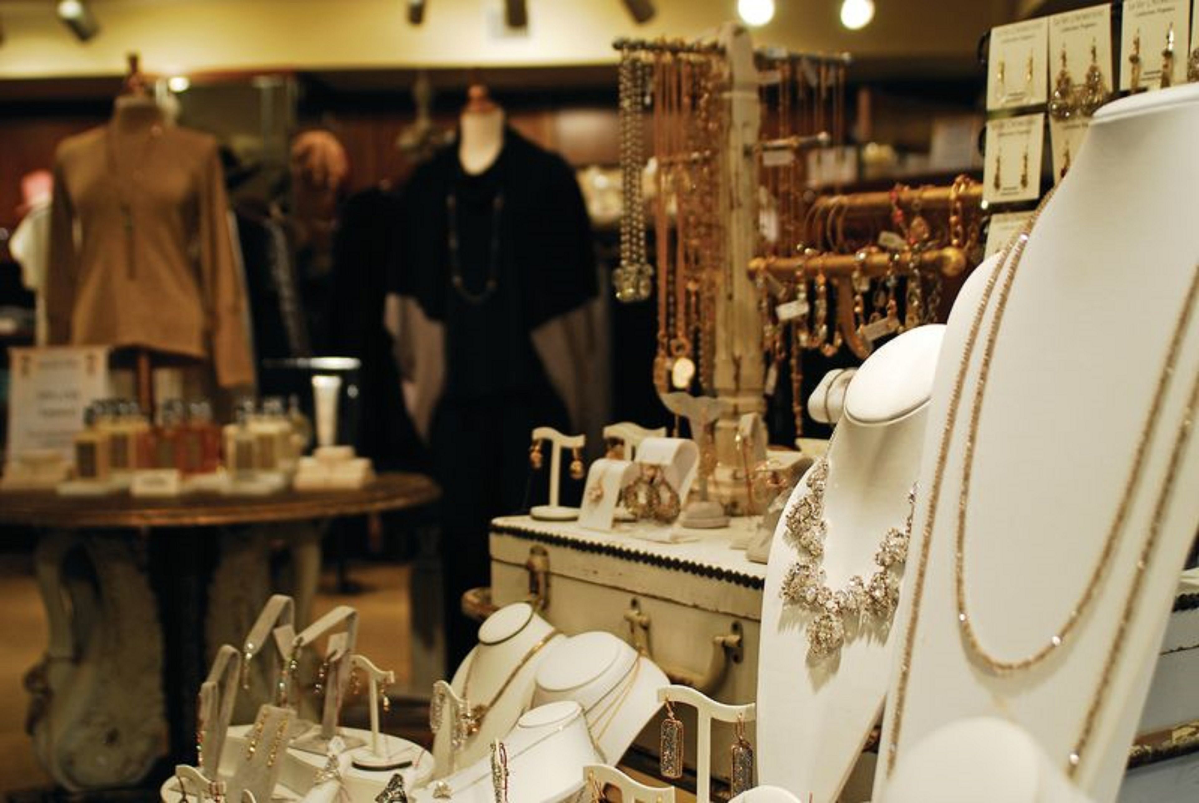 A jewelry store with various items on display, including necklaces and bracelets on mannequins.