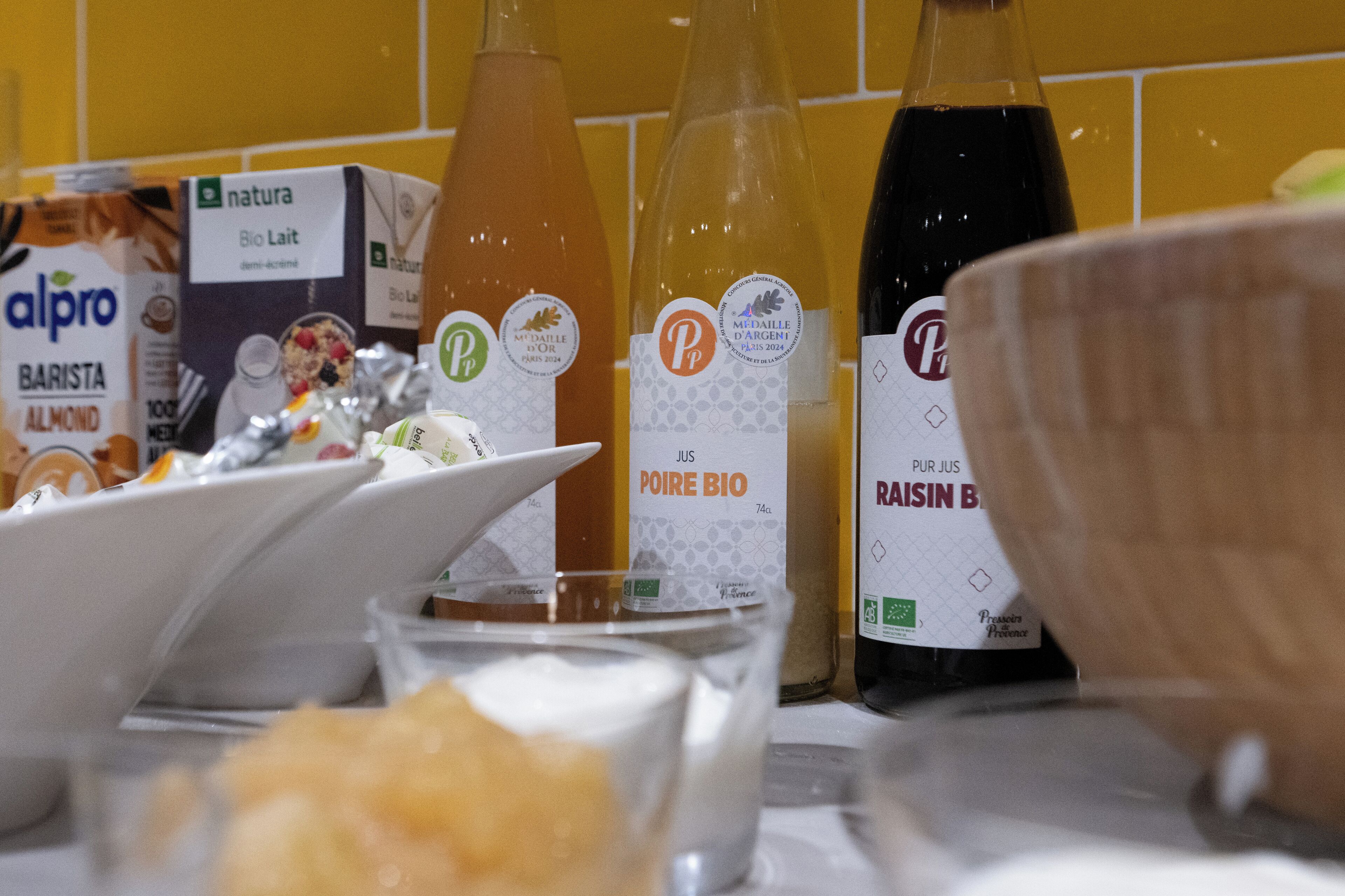 A table with various food items and bottles, including a box labeled 'alpro BARISTA ALMOND'.