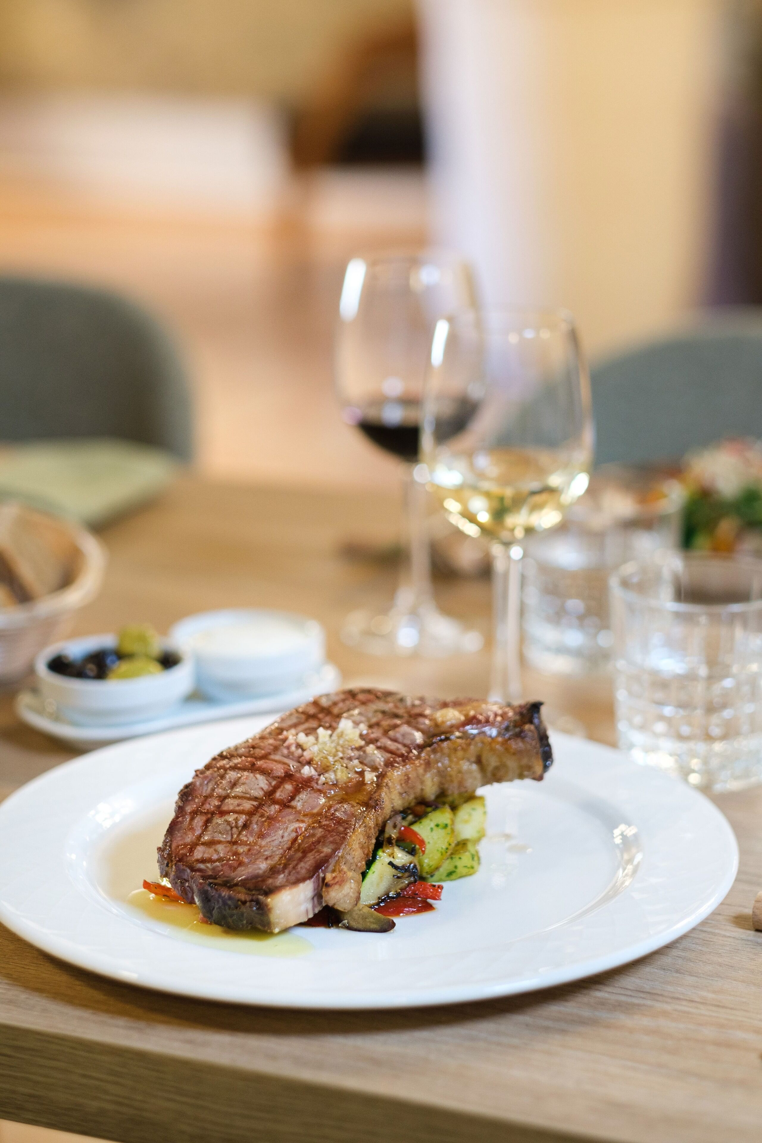 A plate of grilled meat with vegetables on a table.