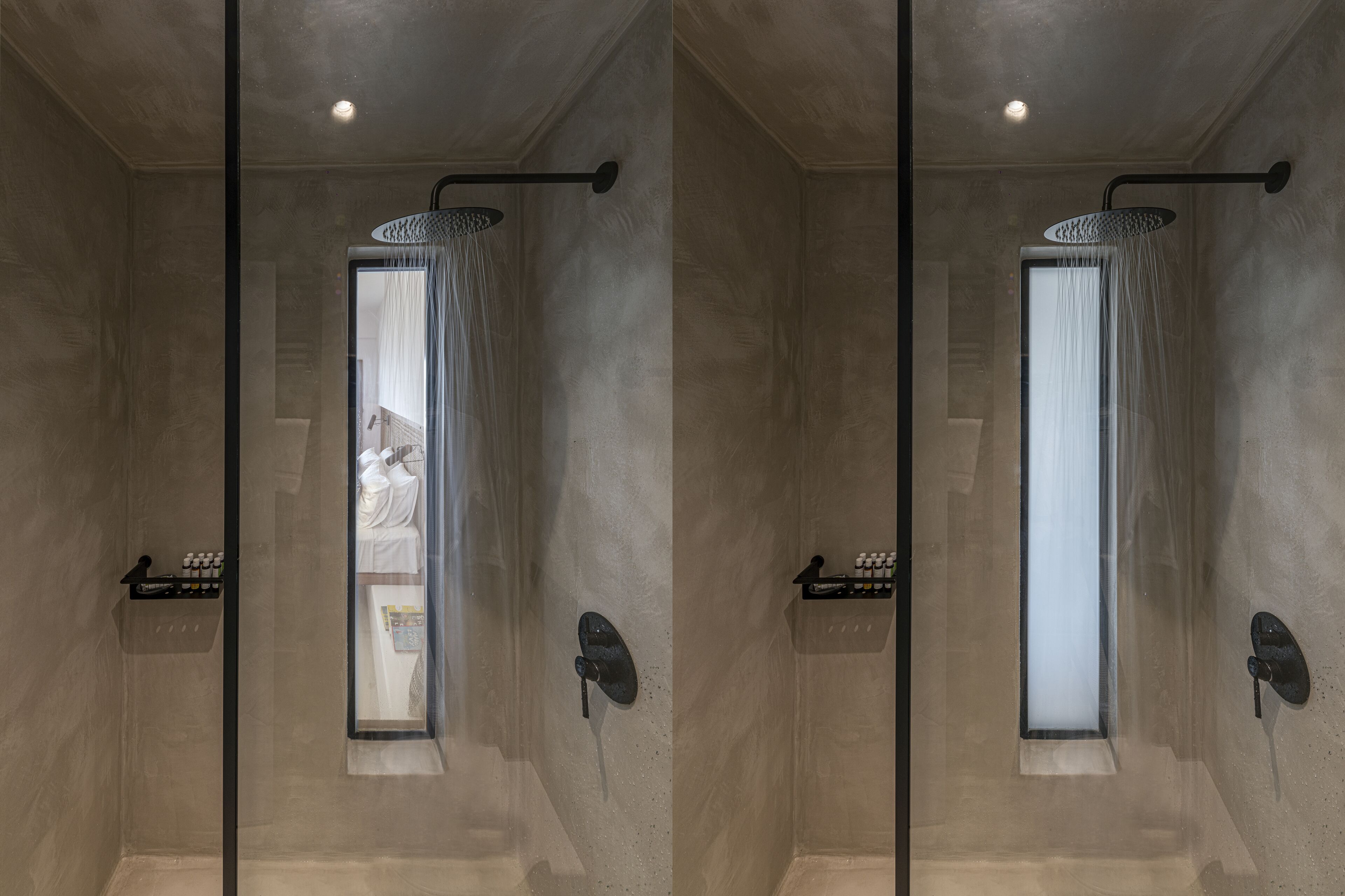 A modern shower with a glass door, a handheld showerhead, and a shelf with toiletries.