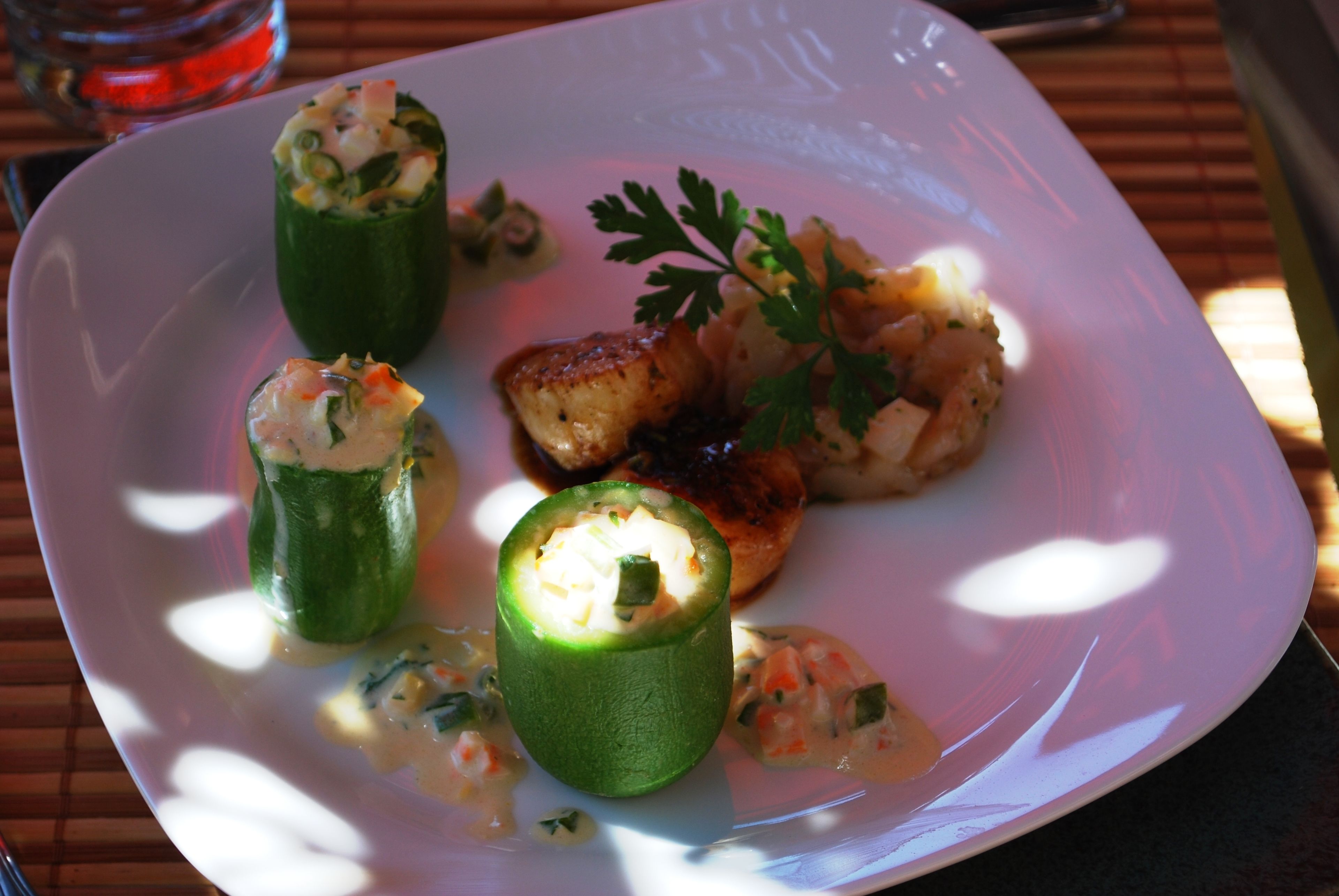 A plate with stuffed vegetables and a garnish.
