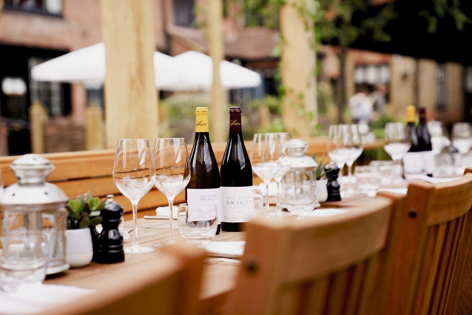 A table set for a meal with wine bottles and glasses.