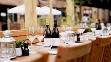 A table set for a meal with wine bottles and glasses.