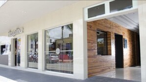 A modern building with large windows and a wooden facade. - Hotel Ha (Orizaba)