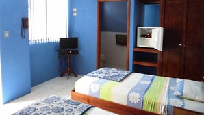 A bedroom with a bed, a wardrobe, a desk with a computer, and an air conditioning unit. - Hotel Francisco I (Salinas)