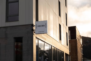 A building with a sign reading 'HELMA HOME HOTEL'.