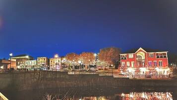 A waterfront area with buildings, a bridge, and a reflection in the water.