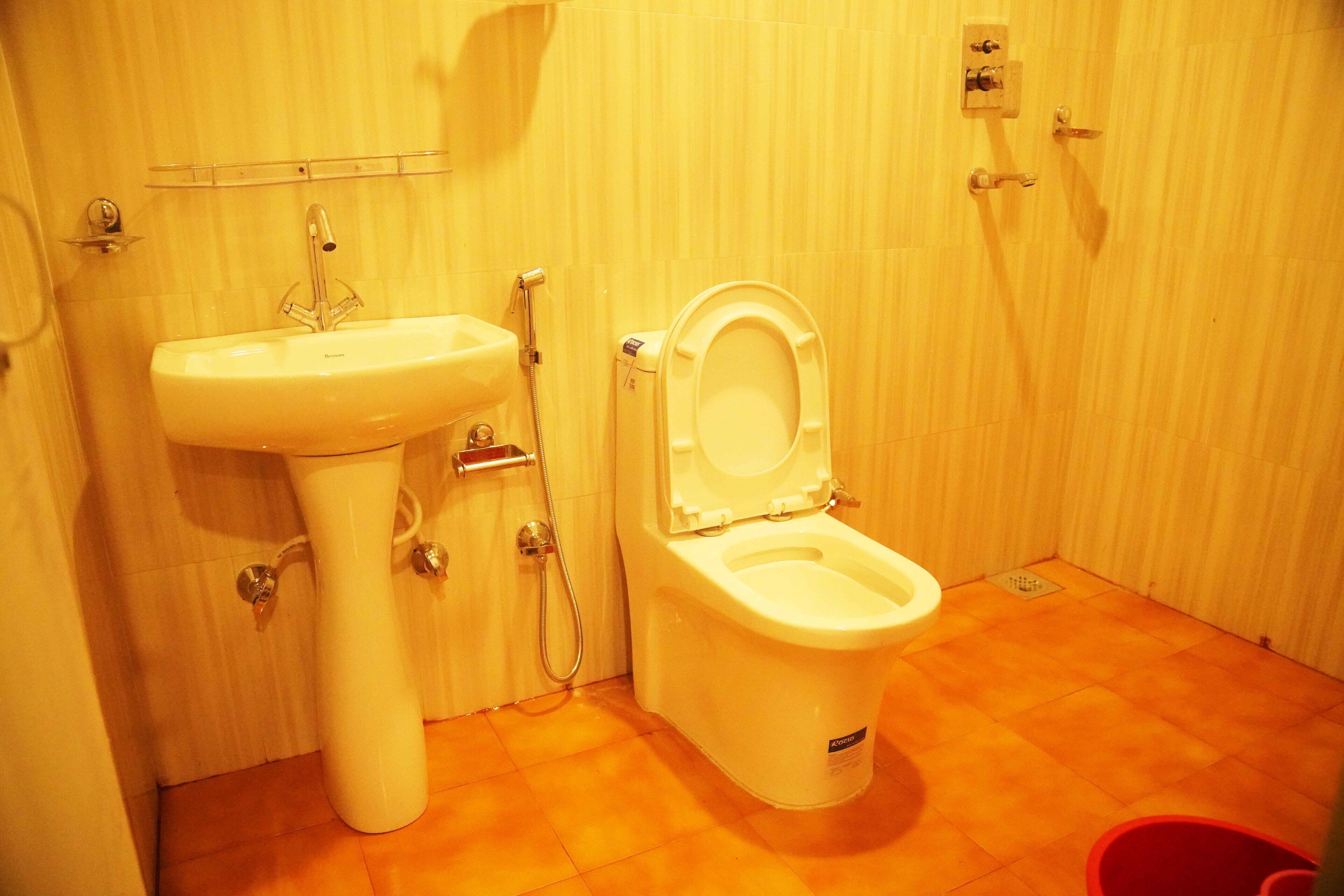 A bathroom with a sink, toilet, and shower.