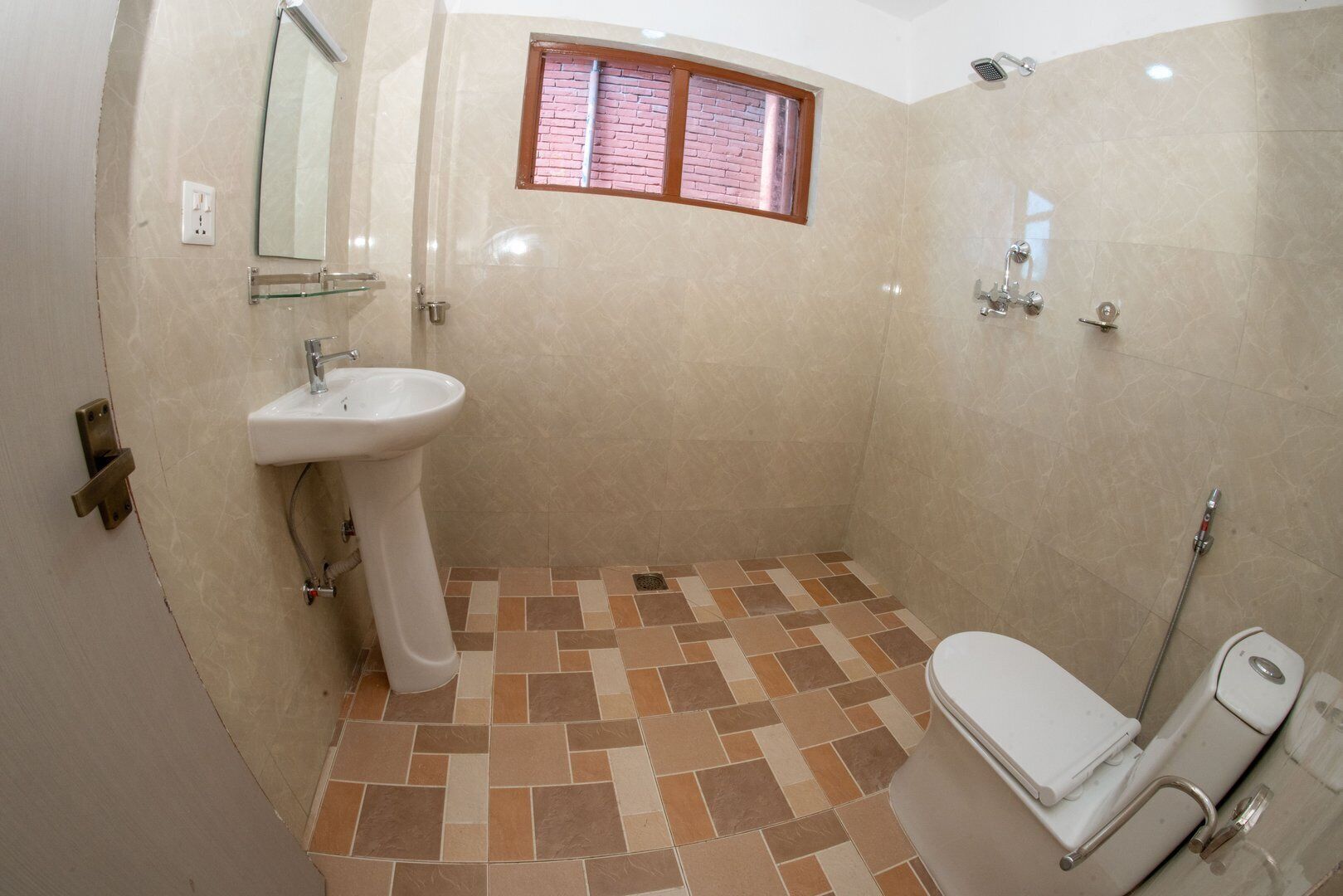 A bathroom with a tiled floor, a sink, a toilet, and a shower.