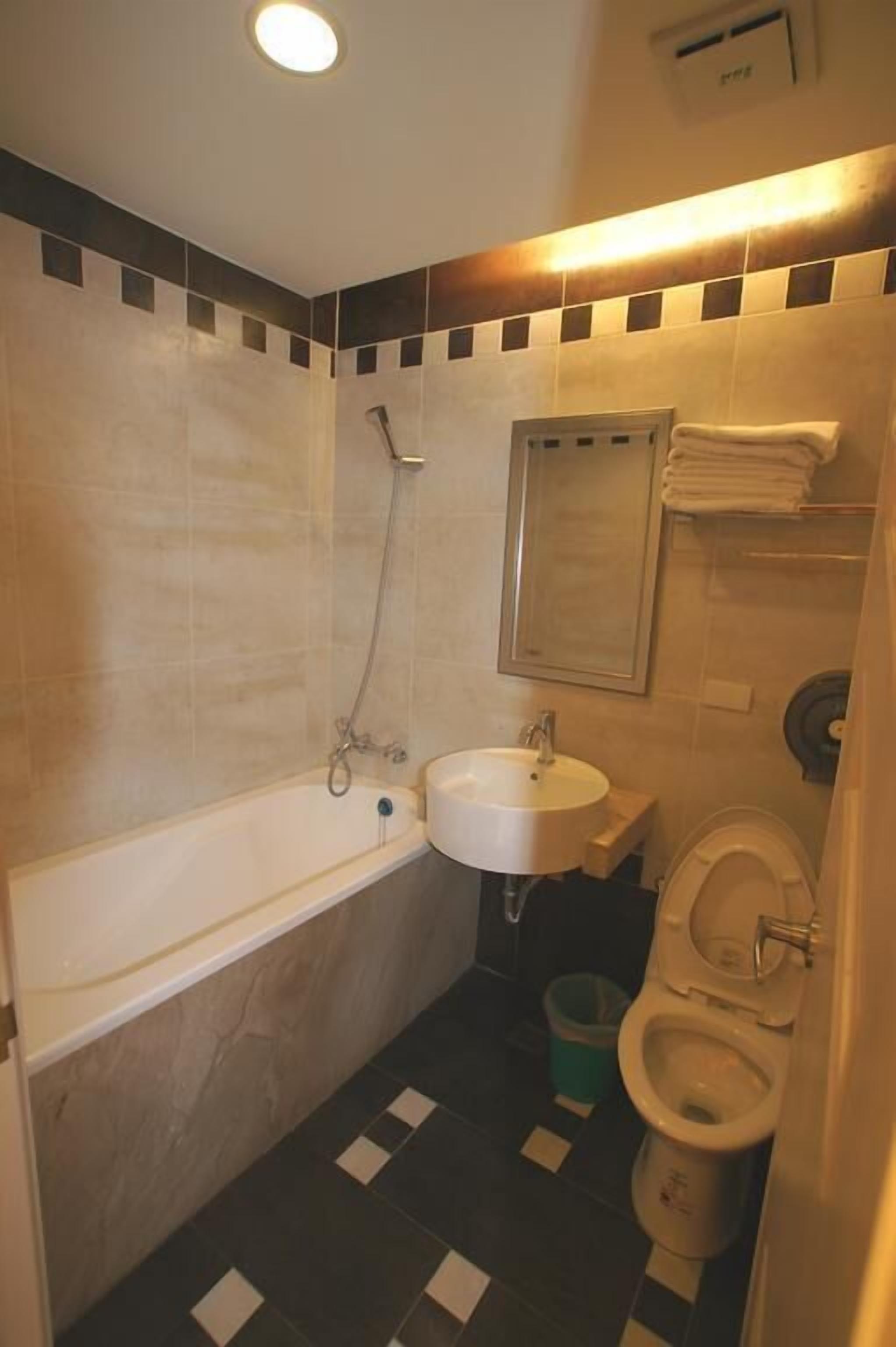 A bathroom with a bathtub, sink, and toilet.