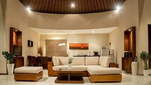 A modern living room with a sofa, coffee table, and a television. - Arsa Villa Bali (Seminyak)