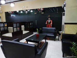 A traditional Japanese-style room with tatami mats, a low table, and a seating area with cushions. - Hotel Sogo Recto (Manila)
