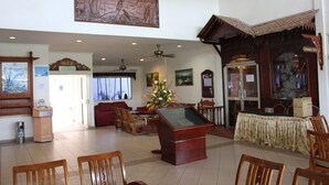 A spacious lobby with a reception desk, seating area, and a large painting on the wall. - Seri Malaysia Bagan Lalang (Sungai Pelek)