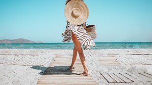 A wooden boardwalk leading to a beach with clear blue water and distant mountains. - Sentido More Meni Residence (Kos)