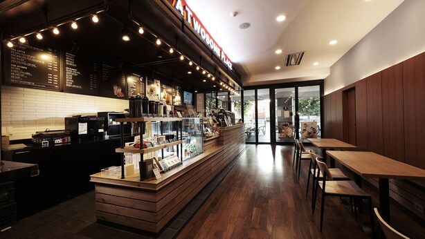 A modern coffee shop interior with a counter, menu boards, and seating area. - Benikea Hotel Pohang (Pohang)