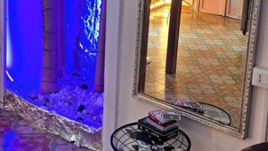 A room with a large mirror, a guitar, and a small drum set. - Exclusive Dependance (Palermo)