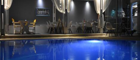 A poolside area with a bar and seating.