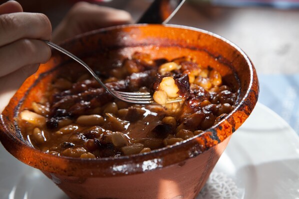 A bowl of beans with a fork.