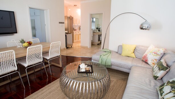 Exclusive Apartment, 1 Bedroom, Mountain View, Beachside | Living room | Flat-screen TV - Caprice Camps Bay (Cape Town)