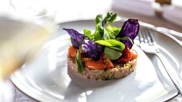 A plated dish with various vegetables and greens.